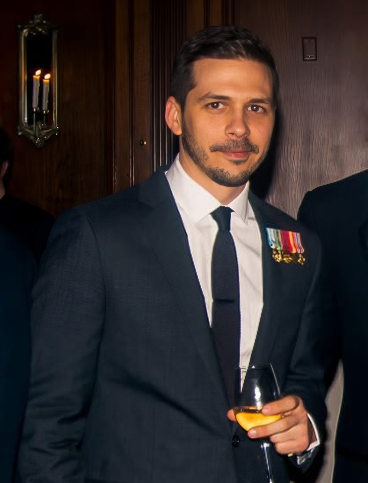 Karim in a suit wearing his service medals